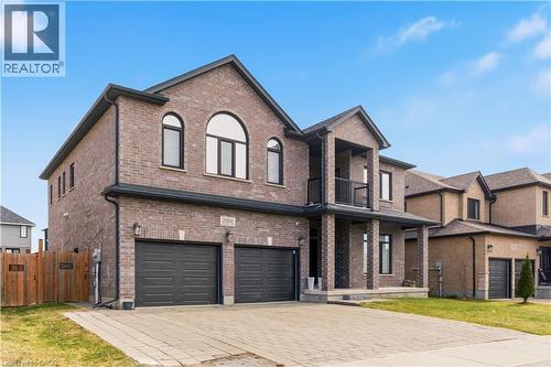 Striking brick exterior with arched windows and a modern architectural design - 2000 Maddex Way, London, ON - Outdoor