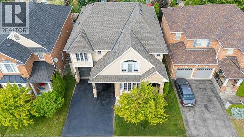 Contemporary residence featuring a light-toned stucco and brick facade with a prominent gabled entrance - 1406 Marshall Crescent, Milton, ON - Outdoor