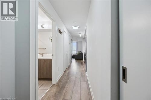 Long hall with wood-finish flooring, white walls, and recessed lighting - 15 Wellington Street S Unit# 903, Kitchener, ON - Indoor Photo Showing Other Room