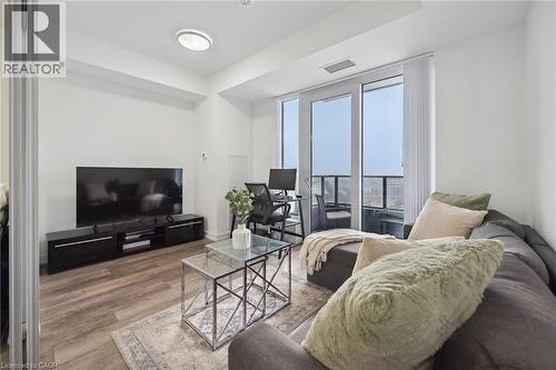 Living area featuring wood-finish flooring, white walls, and a flat-panel ceiling light - 15 Wellington Street S Unit# 903, Kitchener, ON - Indoor Photo Showing Living Room