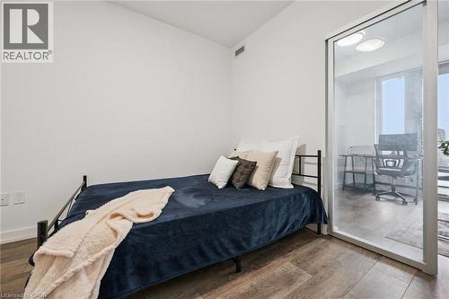 Interior room with wood-finish flooring and white walls - 15 Wellington Street S Unit# 903, Kitchener, ON - Indoor Photo Showing Bedroom