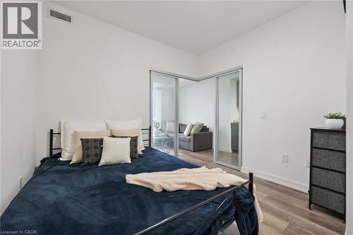 Bright bedroom space with wood-finish flooring - 15 Wellington Street S Unit# 903, Kitchener, ON - Indoor Photo Showing Bedroom