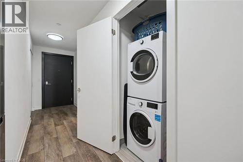 Dedicated laundry closet featuring a stacked washer and dryer - 15 Wellington Street S Unit# 903, Kitchener, ON - Indoor Photo Showing Laundry Room
