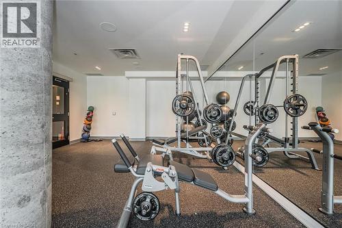 Dedicated fitness space featuring rubber flooring, mirrored wall, and recessed lighting - 15 Wellington Street S Unit# 903, Kitchener, ON - Indoor Photo Showing Gym Room