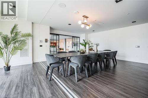 Spacious dining area featuring wide-plank wood-finish flooring with a central accent strip - 15 Wellington Street S Unit# 903, Kitchener, ON - Indoor Photo Showing Dining Room