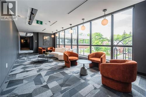 Lounge area featuring a geometric patterned carpet, floor-to-ceiling windows, and recessed lighting - 15 Wellington Street S Unit# 903, Kitchener, ON - Indoor