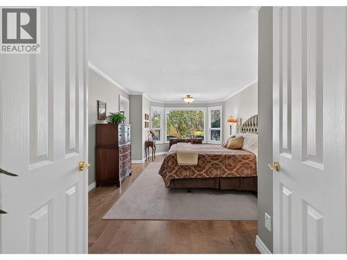 Double French Door Entry to Primary - 3901 Gallaghers Circle, Kelowna, BC - Indoor Photo Showing Bedroom