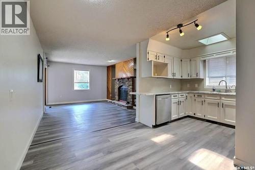 122 Edenwold Crescent, Regina, SK - Indoor Photo Showing Kitchen With Fireplace