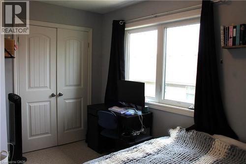 White paneled bi-fold closet doors with brushed nickel hardware - 12 Poplar Drive Unit# 21, Cambridge, ON - Indoor Photo Showing Bedroom