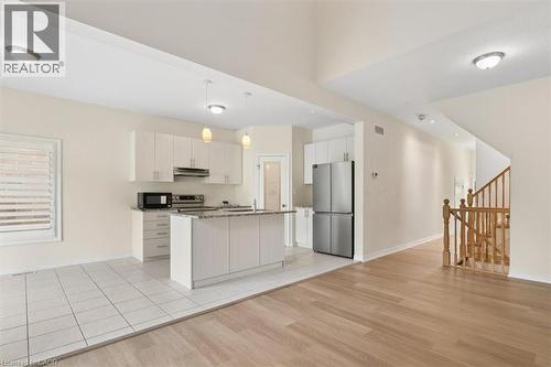 Kitchen with white cabinetry, stainless steel appliances, and island with pendant lighting - 242 Moorlands Crescent, Kitchener, ON - Indoor Photo Showing Kitchen