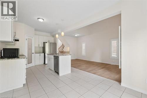 Kitchen featuring white cabinetry, stainless steel appliances, a center island with a sink, and pendant lighting - 242 Moorlands Crescent, Kitchener, ON - Indoor Photo Showing Kitchen
