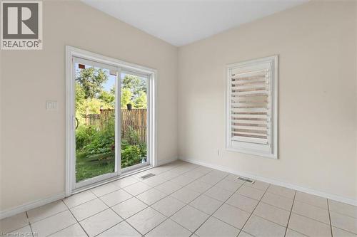 Tile flooring, sliding glass door, plantation shutters, white trim, exterior fencing - 242 Moorlands Crescent, Kitchener, ON - Indoor Photo Showing Other Room