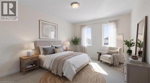 Carpeted flooring, two windows, and a flush mount ceiling light fixture - 242 Moorlands Crescent, Kitchener, ON - Indoor Photo Showing Bedroom