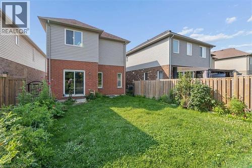 Expansive green space with perimeter fencing and a brick and siding exterior - 242 Moorlands Crescent, Kitchener, ON - Outdoor