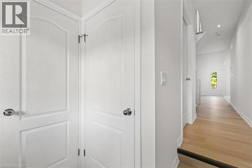 White paneled doors with chrome hardware, light wood-finish flooring, and recessed ceiling lighting - 242 Moorlands Crescent, Kitchener, ON - Indoor Photo Showing Other Room