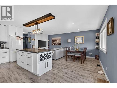 Bright kitchen flows easily into the dining and living areas. - 3703 Commonage Crescent, Vernon, BC - Indoor Photo Showing Kitchen With Upgraded Kitchen