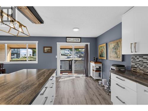 Sliding doors off the kitchen lead to the covered deck. - 3703 Commonage Crescent, Vernon, BC - Indoor