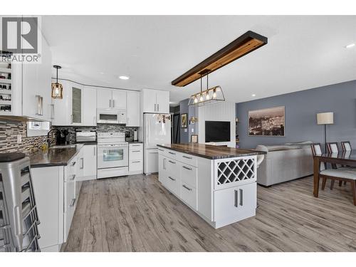 Bright kitchen with a spacious island and plenty of cabinetry. - 3703 Commonage Crescent, Vernon, BC - Indoor Photo Showing Kitchen