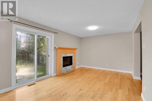 Family Room with Entrance to Private Backyard - 28 Weybridge Drive, Ottawa, ON - Indoor With Fireplace