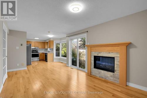 Family Room and Kitchen - 28 Weybridge Drive, Ottawa, ON - Indoor Photo Showing Living Room With Fireplace