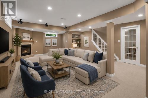 Lower Level Recreation Room - Virtually Staged - 28 Weybridge Drive, Ottawa, ON - Indoor Photo Showing Living Room With Fireplace