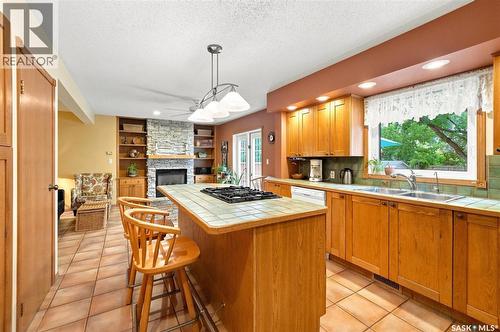 Crescent 211 David Knight Crescent, Saskatoon, SK - Indoor Photo Showing Kitchen With Fireplace With Double Sink