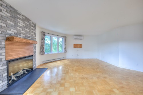 Salon - 201-2050 Rue De Magenta, Laval (Vimont), QC - Indoor With Fireplace