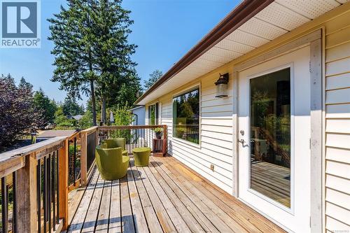 Wood deck with access to brand new stairs, full-light door, and exterior sconce.  Perfect place for your morning coffee. - 4105 Ross Rd, Nanaimo, BC - Outdoor With Deck Patio Veranda With Exterior