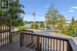 Expansive outdoor deck with wood-finish railing and stairs - 