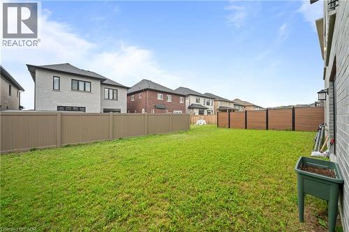 Expansive lawn area featuring a combination of tan panel fencing and dark wood-look fencing - 130 Pondcliffe Drive, Kitchener, ON - Outdoor