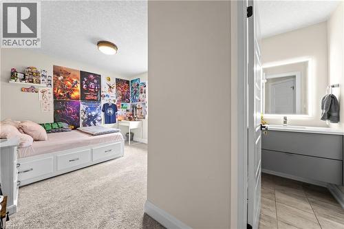 Carpeted room with a built-in bed frame featuring storage drawers - 130 Pondcliffe Drive, Kitchener, ON - Indoor