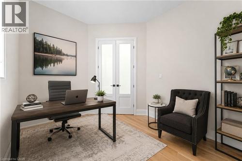 Private room featuring light-toned walls, light wood-finish flooring, and double French doors with frosted glass panels - 130 Pondcliffe Drive, Kitchener, ON - Indoor Photo Showing Office