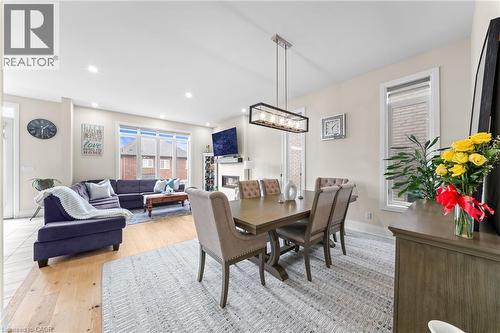 Spacious open-concept interior featuring light wood-finish flooring, recessed lighting, and large windows - 130 Pondcliffe Drive, Kitchener, ON - Indoor