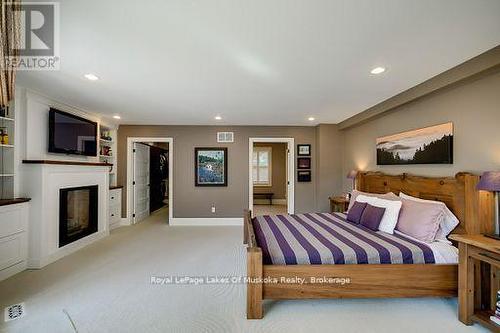 230 Ecclestone Drive, Bracebridge, ON - Indoor Photo Showing Bedroom With Fireplace