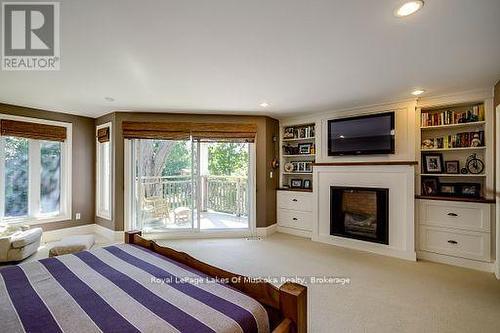 230 Ecclestone Drive, Bracebridge, ON - Indoor Photo Showing Bedroom With Fireplace