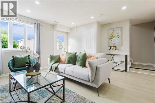 Recessed lighting, light wood-finish flooring, white trim, and a white door - 67 Kinzie Avenue, Kitchener, ON - Indoor Photo Showing Living Room