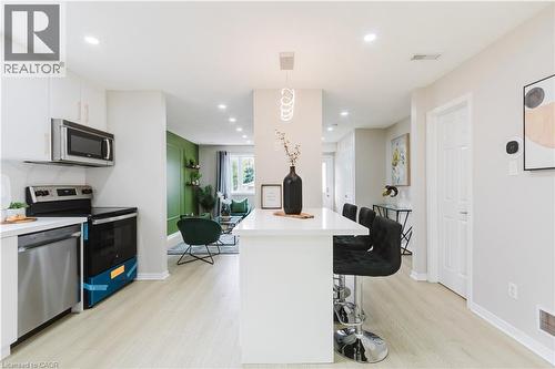 Modern kitchen with white cabinetry and stainless steel appliances - 67 Kinzie Avenue, Kitchener, ON - Indoor Photo Showing Kitchen