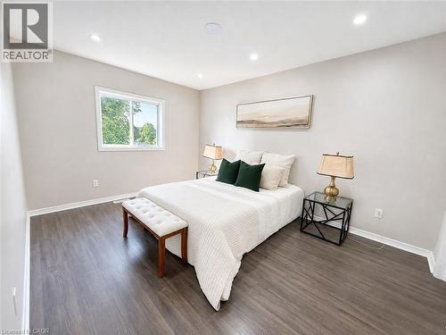 Recessed lighting, wood-finish flooring, white trim, and a window with white casing - 67 Kinzie Avenue, Kitchener, ON - Indoor Photo Showing Bedroom