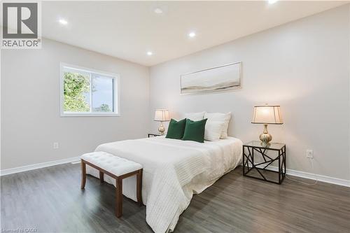 Recessed lighting, wood-finish flooring, white trim, and a window with a white frame - 67 Kinzie Avenue, Kitchener, ON - Indoor Photo Showing Bedroom