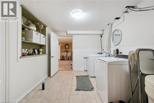 Laundry area with tile flooring and built-in shelving - 589 Elgin Street N, Cambridge, ON - Indoor Photo Showing Laundry Room