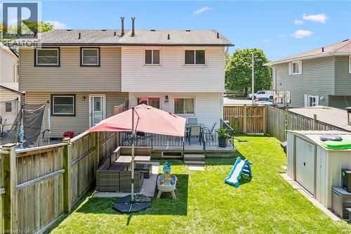 Private backyard with fenced perimeter, green lawn, exterior deck, and storage shed - 589 Elgin Street N, Cambridge, ON - Outdoor With Deck Patio Veranda With Exterior