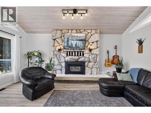 Stone fireplace anchors the space - 3491 Fenton Road, West Kelowna, BC - Indoor Photo Showing Dining Room