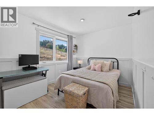 Secondary bedroom on the main level - 3491 Fenton Road, West Kelowna, BC - Indoor Photo Showing Bedroom