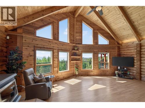 Large windows to capture natural light - 7319 Trapper Court, Kelowna, BC - Indoor With Fireplace