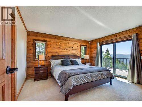 Primary bedroom with an additional entrance to the patio - 7319 Trapper Court, Kelowna, BC - Indoor Photo Showing Bedroom