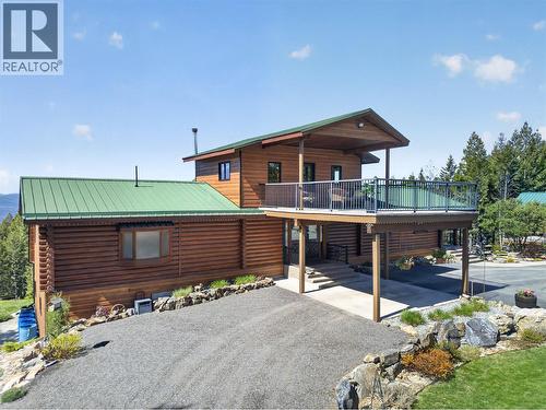 Home is a stunning log cabin - 7319 Trapper Court, Kelowna, BC - Outdoor With Deck Patio Veranda