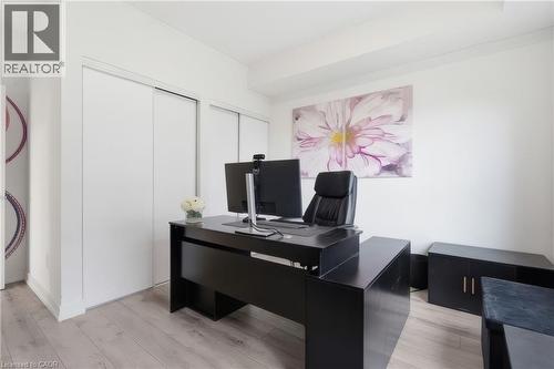 Wood-finish flooring with white walls and built-in closet doors - 251 Northfield Drive E Unit# 312, Waterloo, ON 