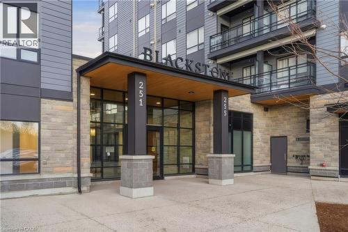 Stone veneer facade with wood-finish soffit entry - 251 Northfield Drive E Unit# 312, Waterloo, ON 