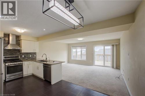 Open-concept living space with a kitchen island, stainless steel appliances, and tile backsplash - 193 Mccann Street, Guelph, ON - Indoor Photo Showing Kitchen