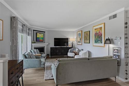 308-70 Dunkirk Dr, Winnipeg, MB - Indoor Photo Showing Living Room With Fireplace